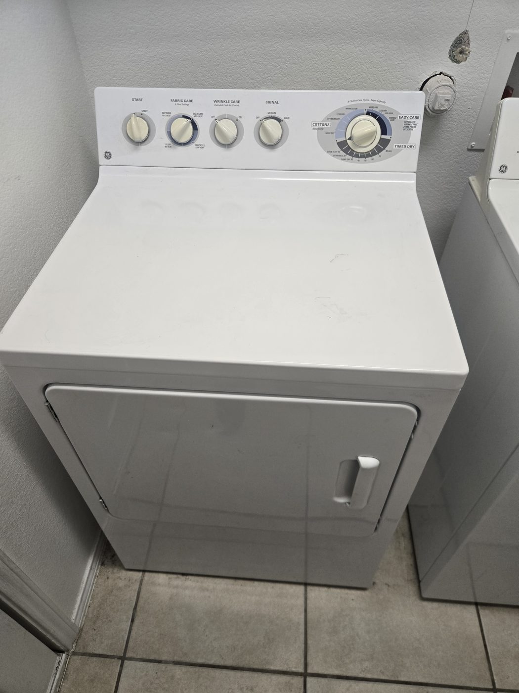 A white top-load dryer serviced during a no-heat call