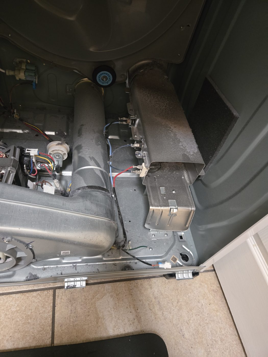 Oven and range internals exposed, showing gas and high-voltage components