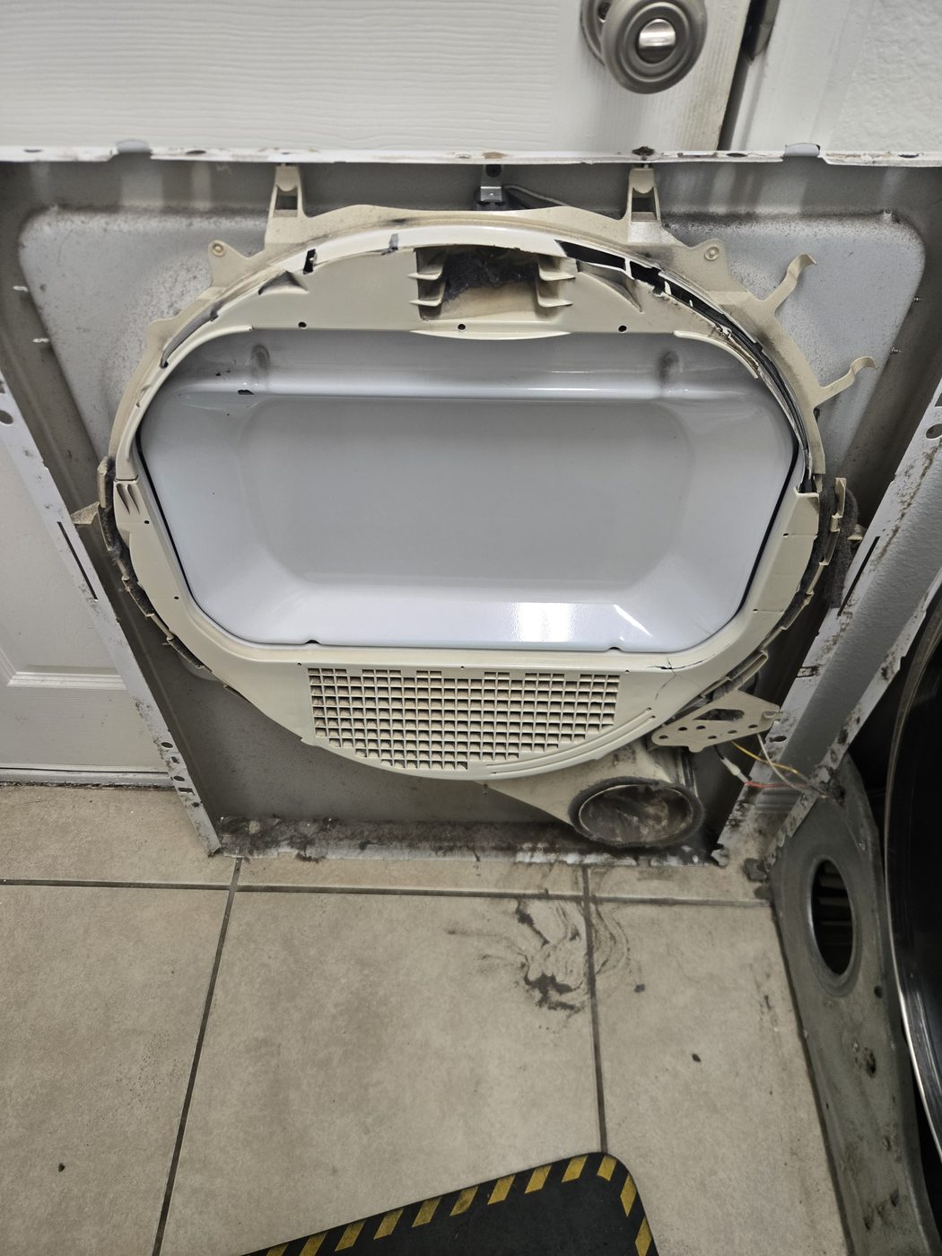 A washer opened up on a laundry-room floor during a drain repair