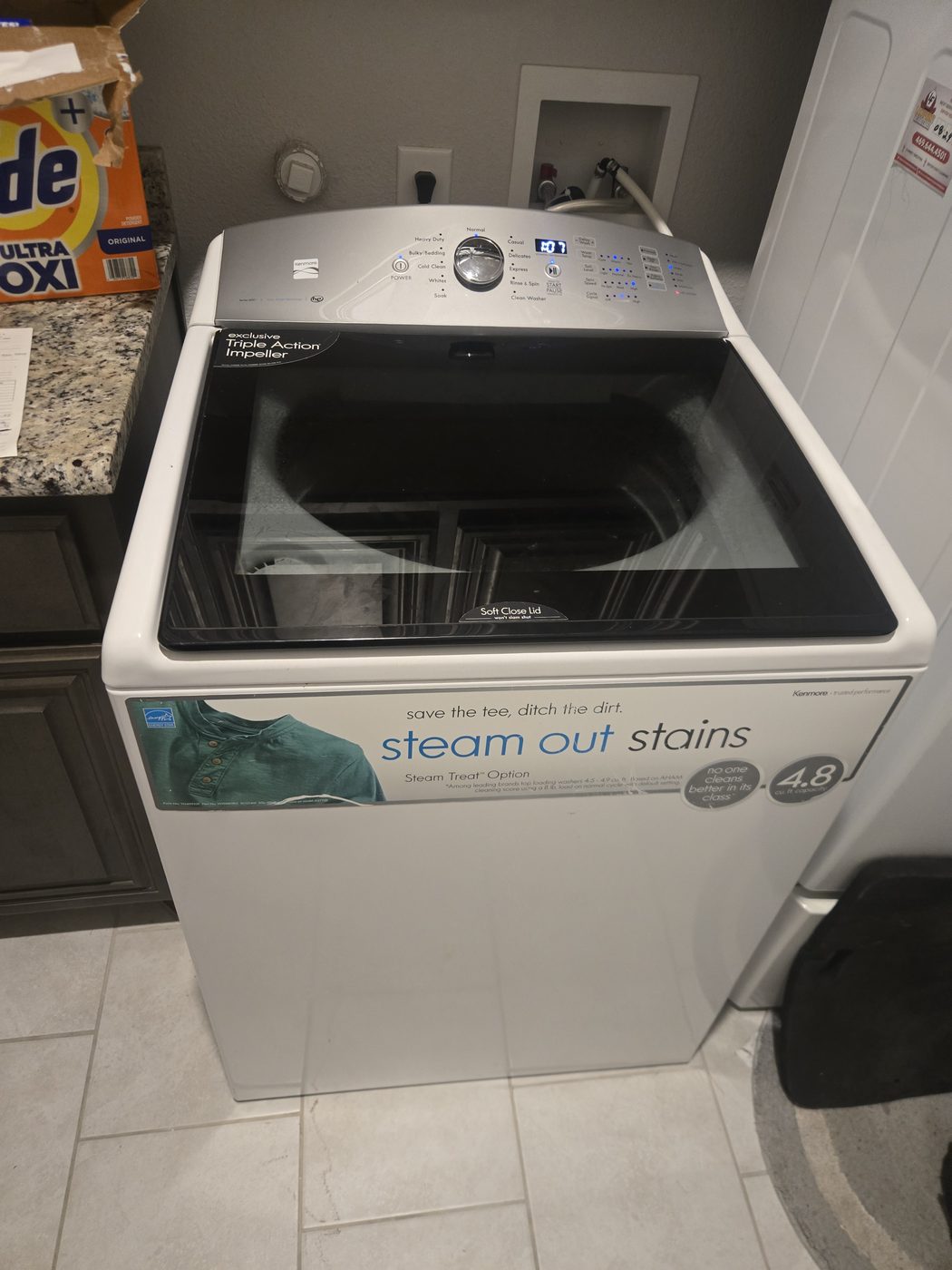 Top-load washer in a laundry room