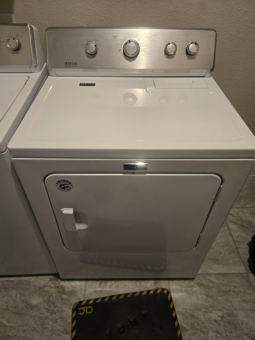 White dryer in a home laundry room