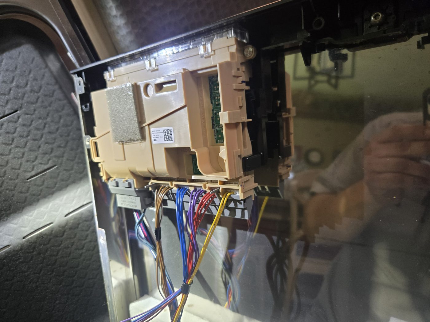 Appliance control board with wiring harness exposed for testing